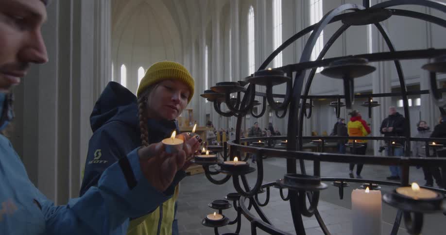 A man is lighting candles in church