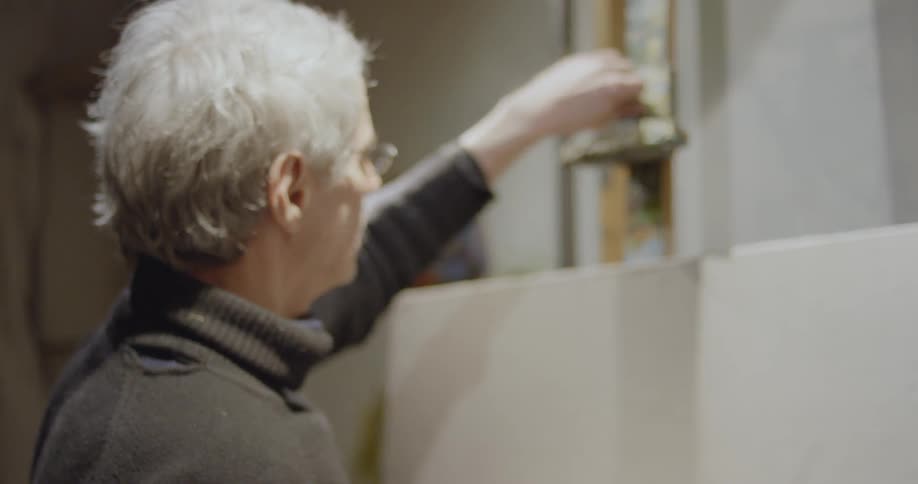 An artist puts a blank canvas on an easel