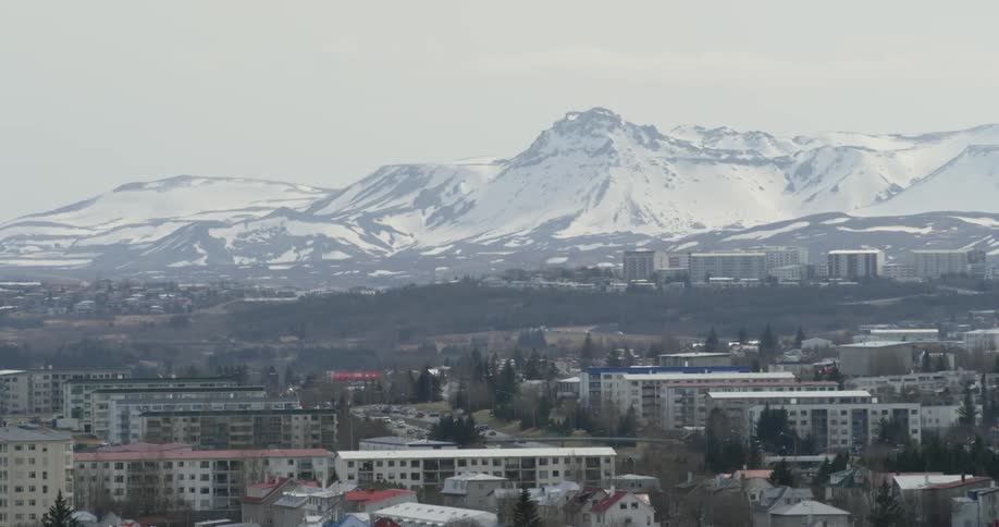 A city at the base of a snowy mountain
