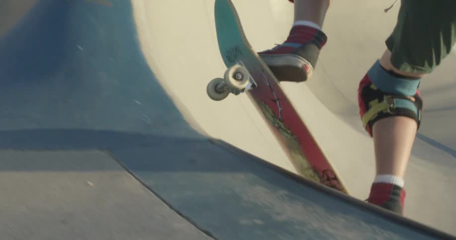 A skateboarder jumps up on a ramp