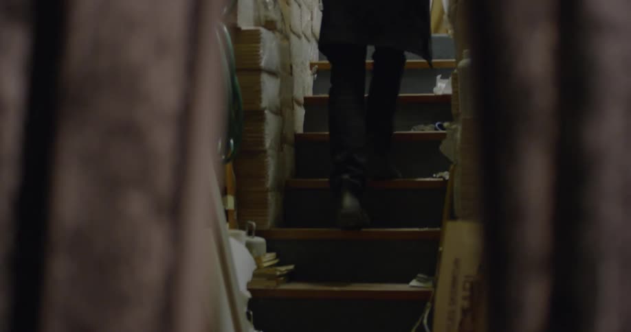 Person walking up basement stairs