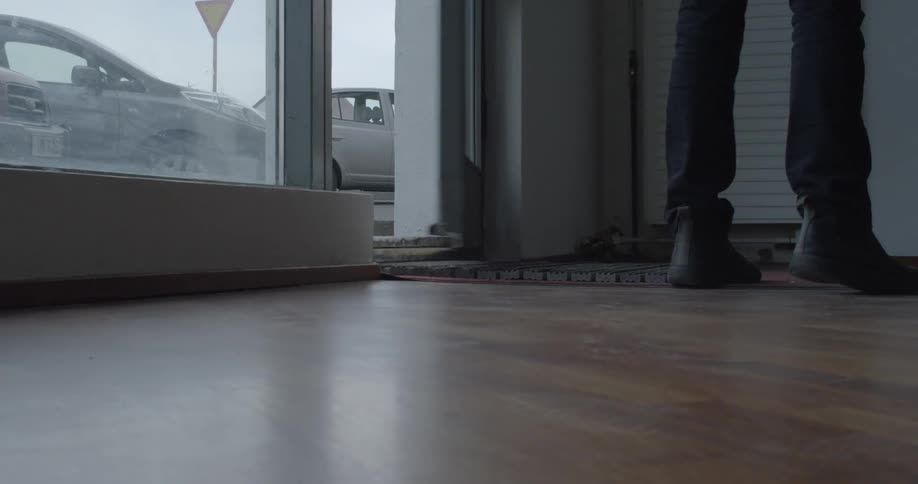 A man enters a shop and closes the door
