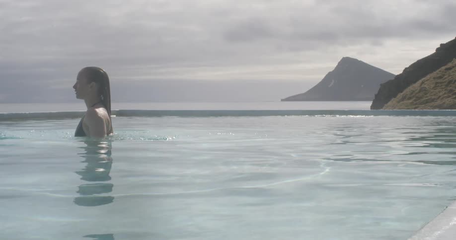 A woman is swimming in a hot spring