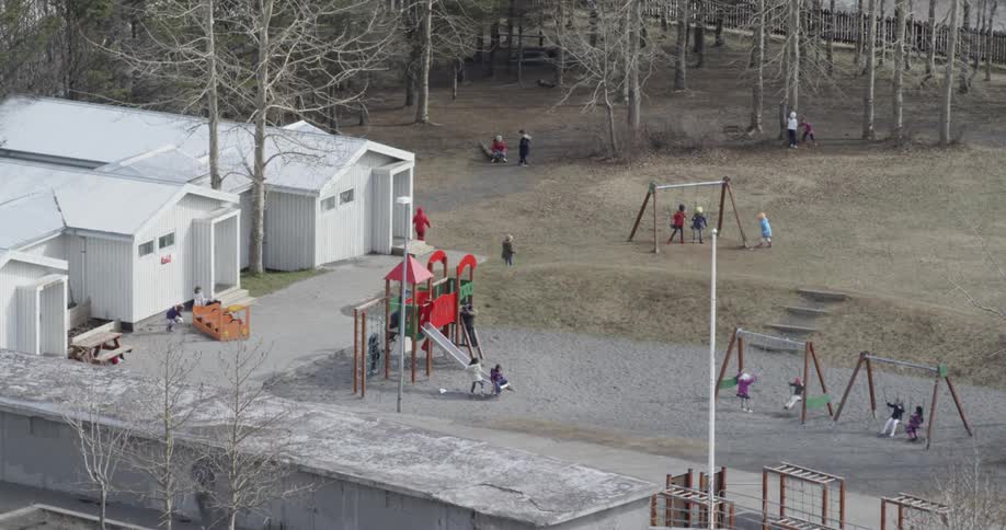 Kids are playing on the playground in a park