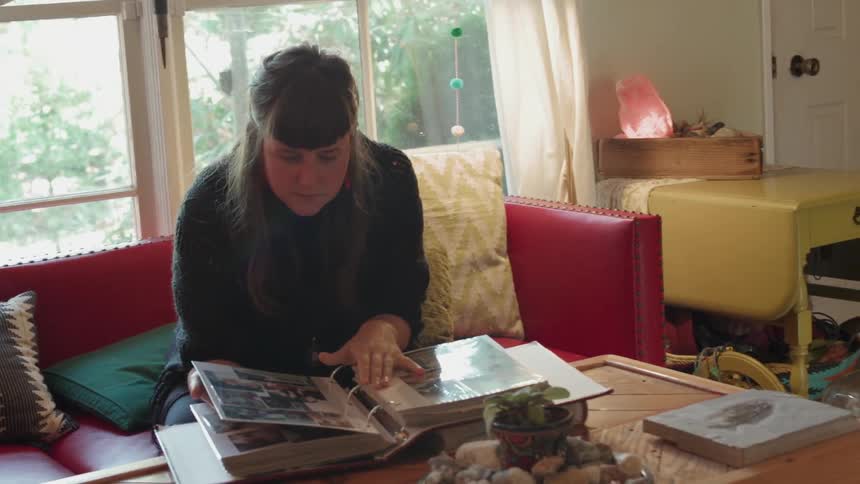 A woman looks through a photo album