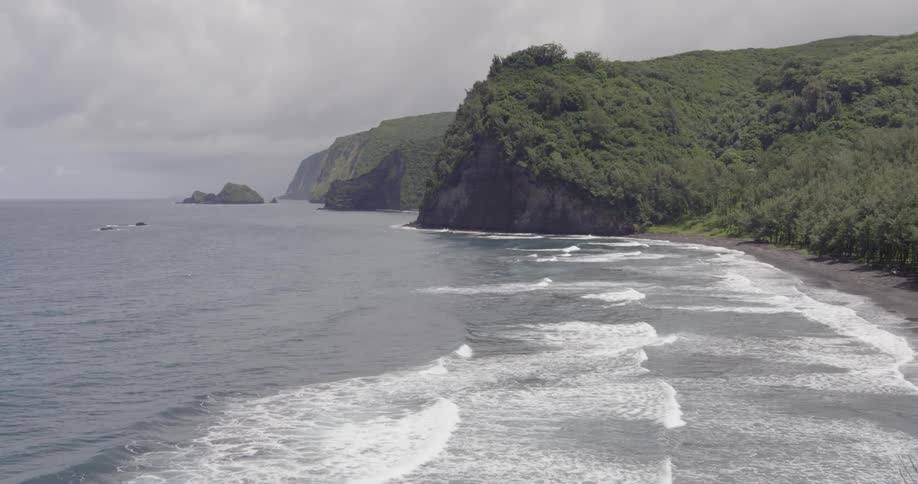 Water flows up to the beach on a cloudy day