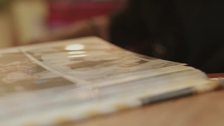 A woman flips through a photo album