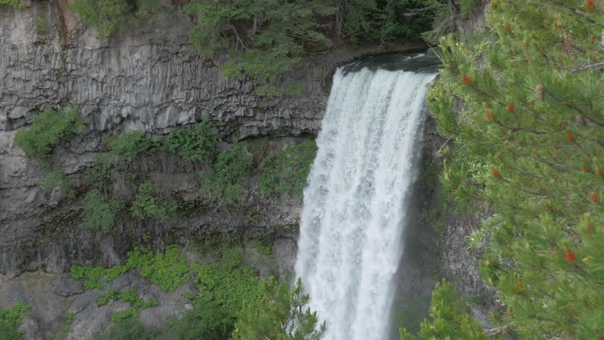 A waterfall is falling down the side of a cliff