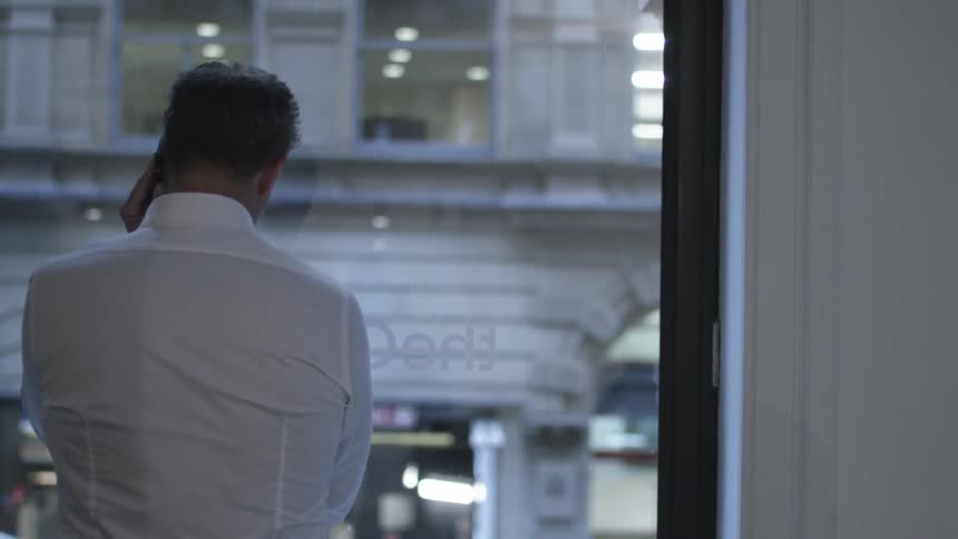 A person standing in front of a window