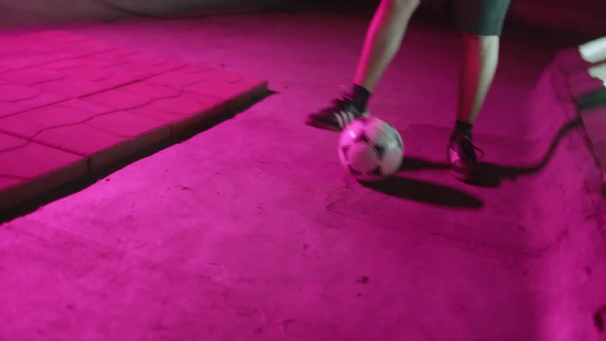 A person is kicking a soccer ball around