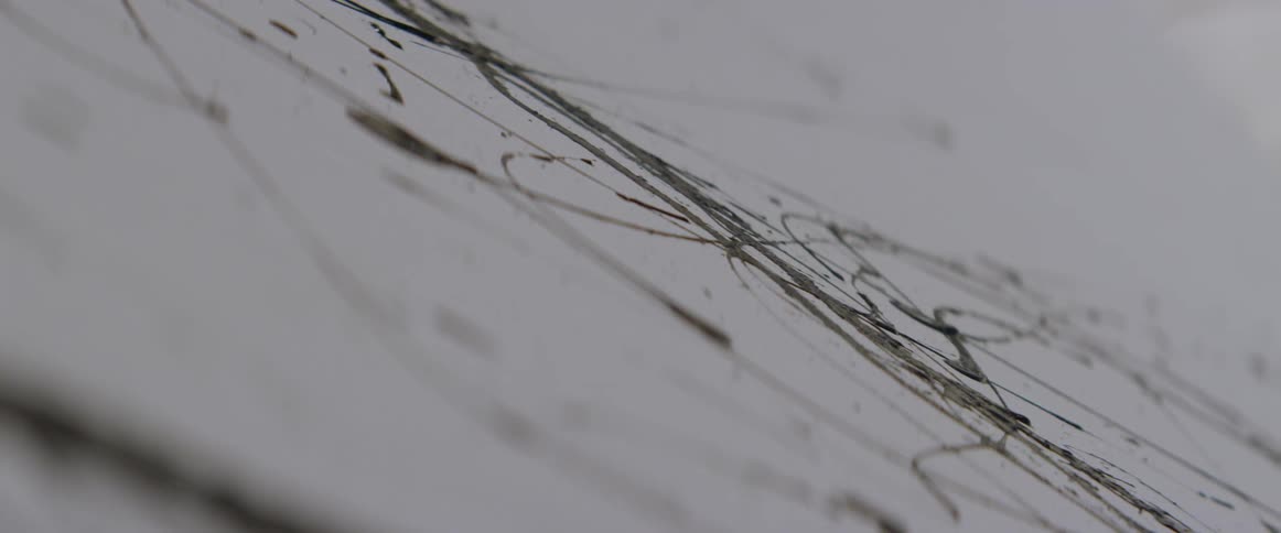 Paint is dripped on a canvas