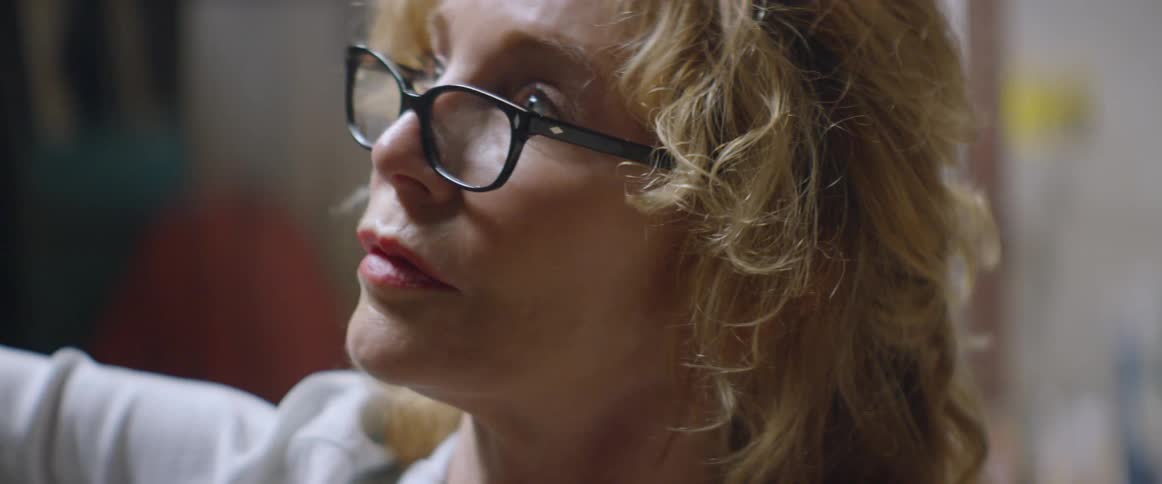 A woman is wearing glasses inside