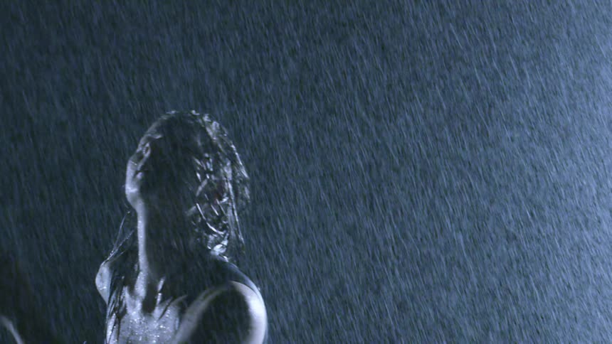 A woman dances in the rain