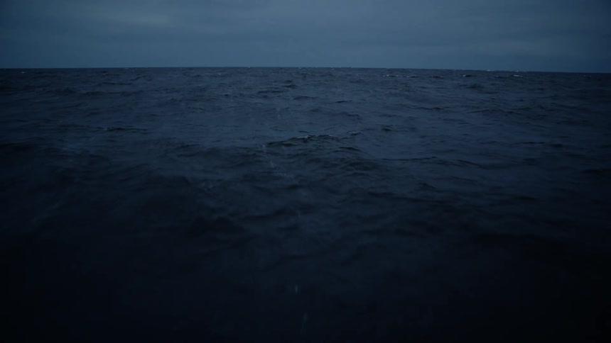 The ocean is calm at dusk