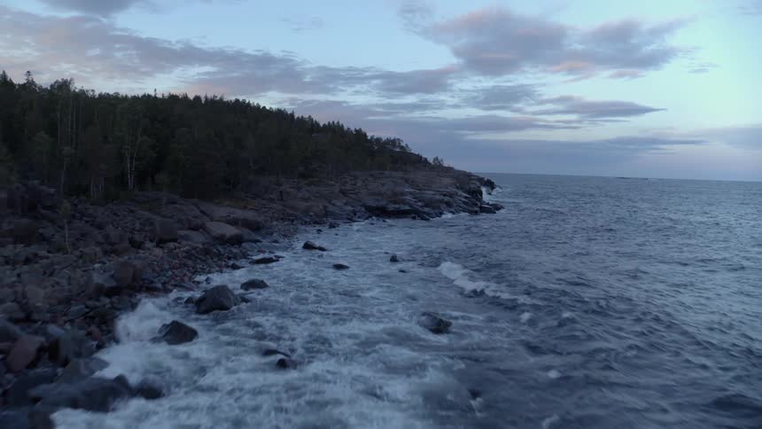 Waves flow onto the rocky shore