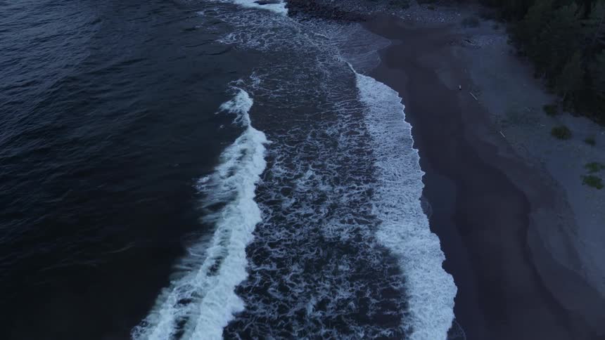 Waves flow onto the beach shore