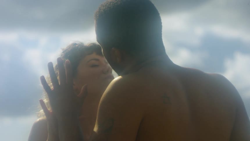 A man and woman are touching palms naked outdoors