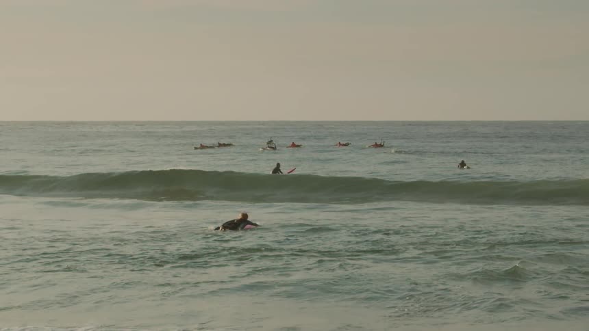 A surfer swims in the ocean
