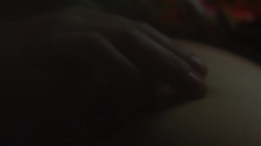 A hand touches bare skin