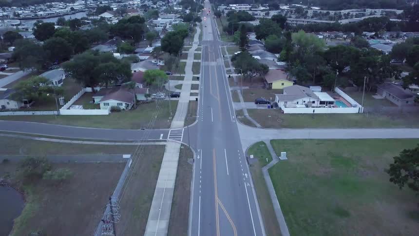 A vehicle travels down a town road