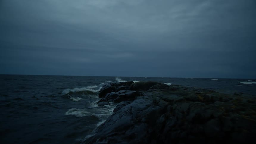 A choppy ocean after sunset