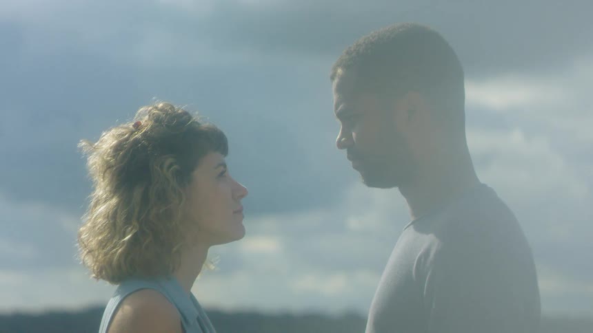 A man and woman stare at each other lovingly outside