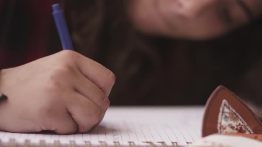 A person writing on paper