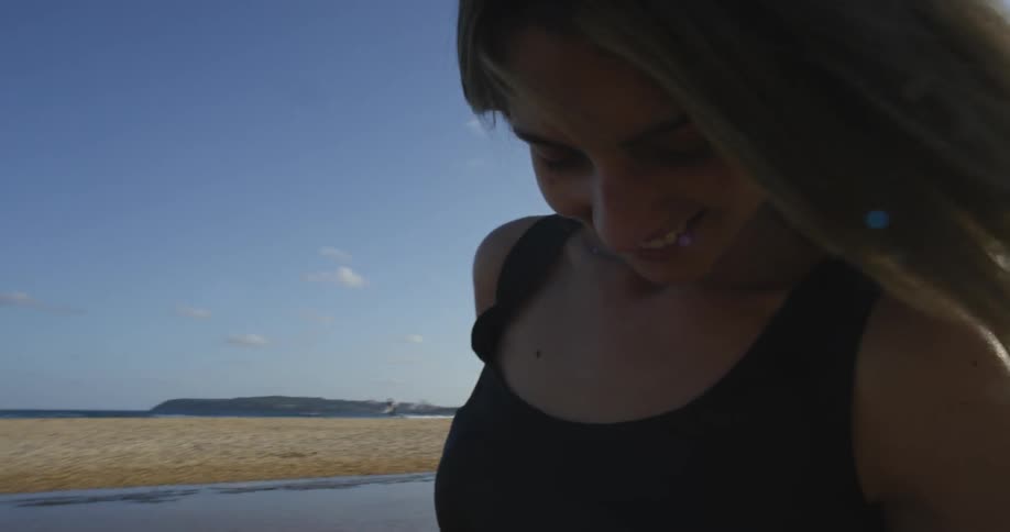 Woman in a black dress in front of a lake