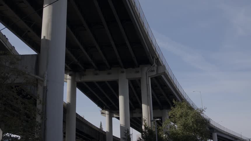 A city bridge stands overhead