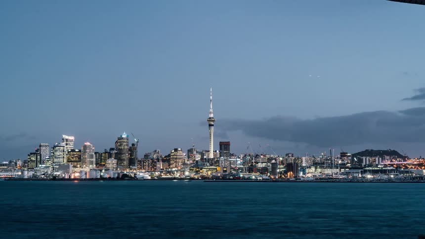 Sailboats travel on the water by the city