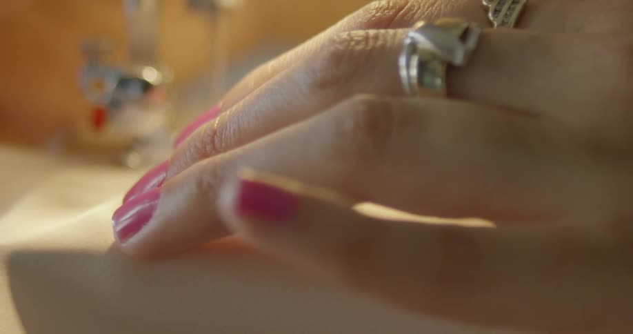 Close up of a woman using a sewing machine
