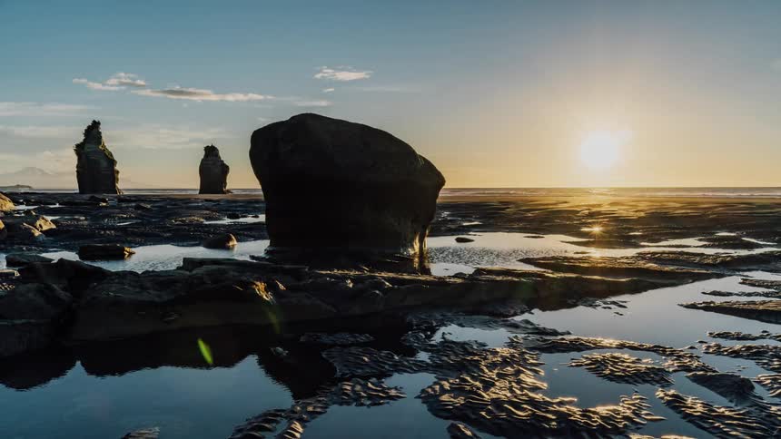 A rocky beach at sunset