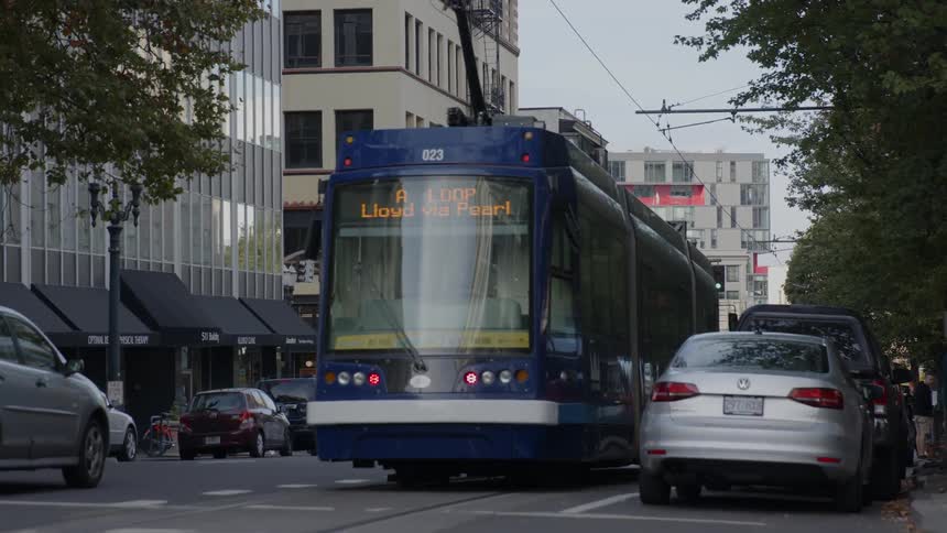 A trolley car travels down a city road