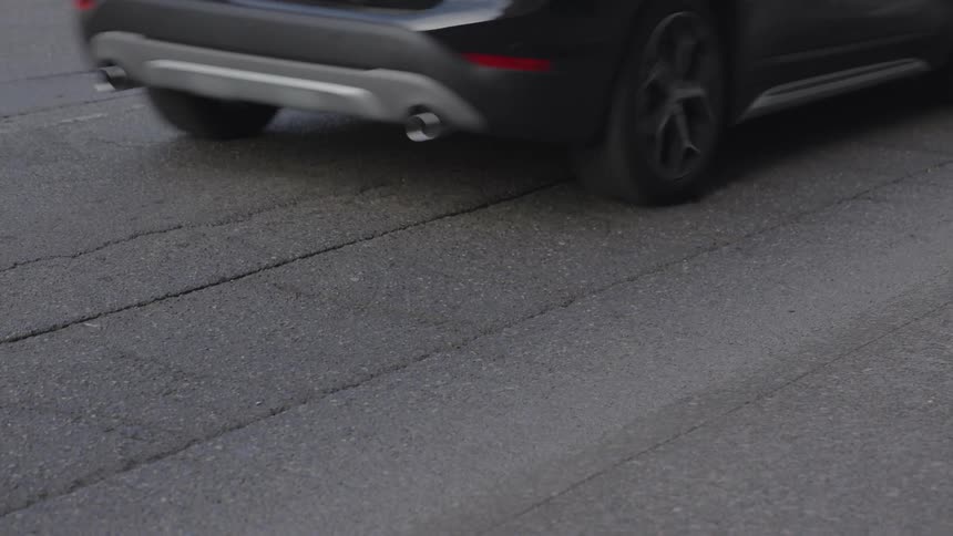 Cars drive on a paved street
