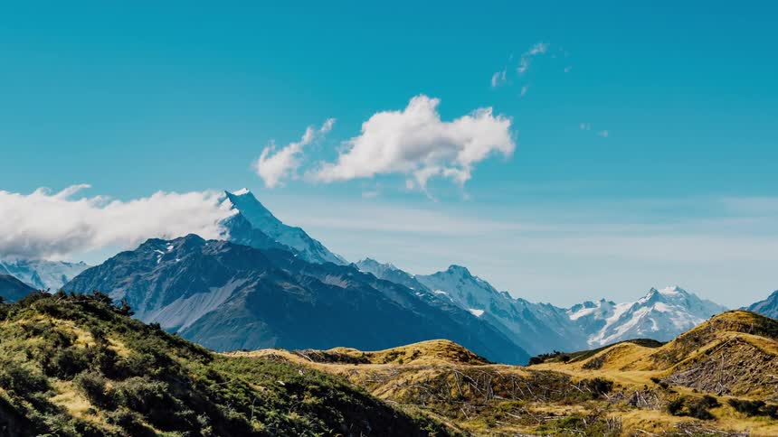 Clouds rolling over jagged mountains