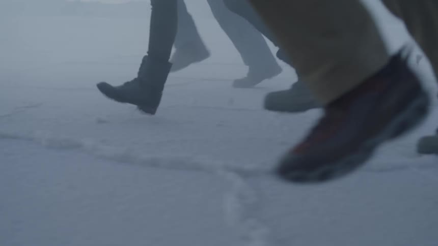 People run across salt flats at sunset