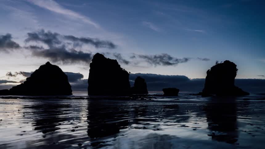Clouds are drifting over a beach at dawn
