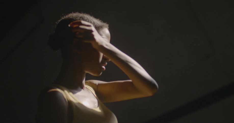 A woman wipes her face