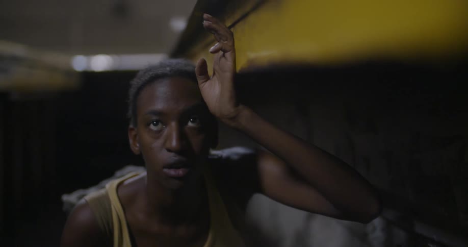 A person hides under a yellow ledge