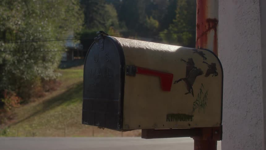 The sun shines on a mailbox in a rural area