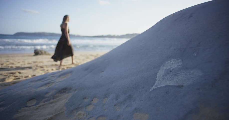 A woman goes for a stroll on the beach
