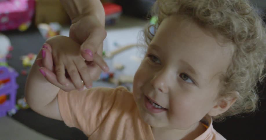 An adult holding a child's hand