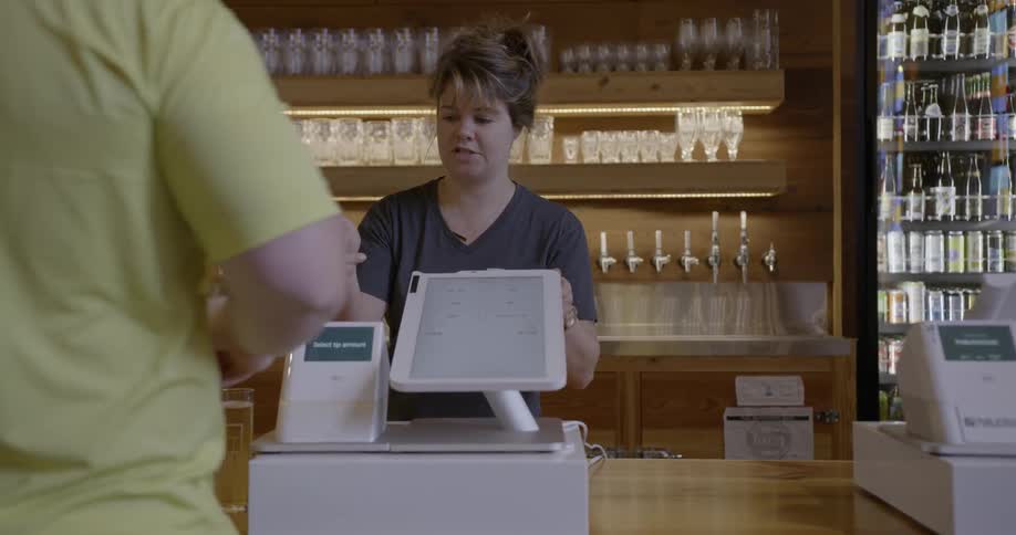 A woman is checking out a customer