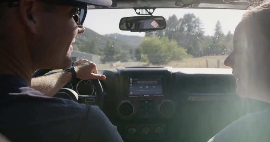Father and daughter driving down a country road
