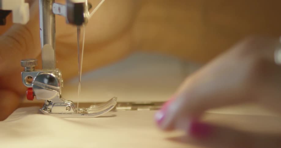 A woman sews with a sewing machine