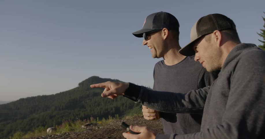 Two men pointing and laughing on a mountain