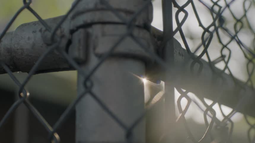 A chain link fence is filmed close up