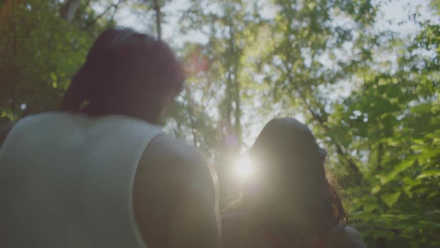 Man and woman walk in a forest