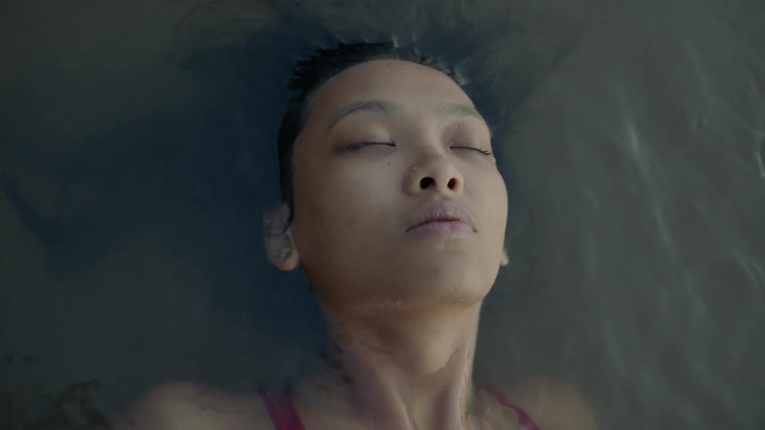 Woman swims in a lake