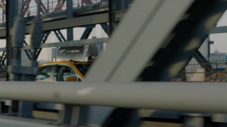 A taxi is crossing a steel bridge